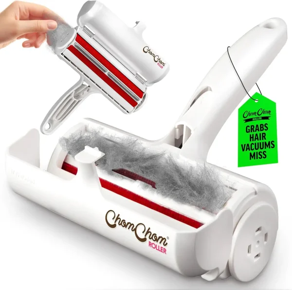 A white ChomChom Roller pet hair remover held against a grey fabric sofa covered in white cat fur.